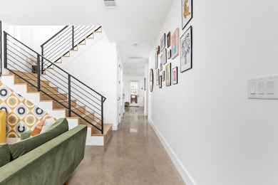 Hall featuring stairs, baseboards, and finished c