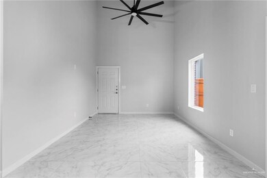 Unfurnished room with a high ceiling and ceiling fan
