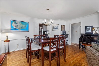 Dining room with chair rail, crown molding, and ha
