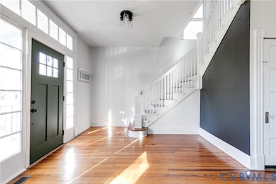 Foyer with stairs and hardwood / wood-style floors