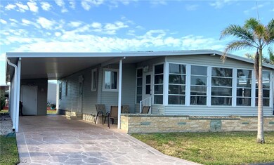 Front Elevation w/Long Drive & Carport