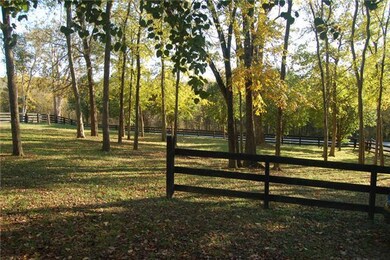 Front yard features mature trees, fully fenced.
