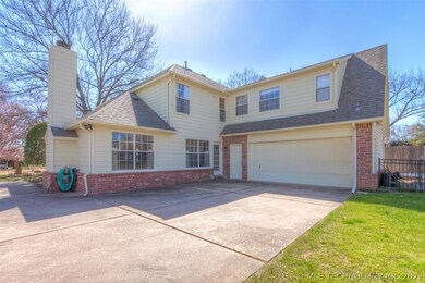 Backside view of home with side entry garage
