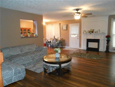 Living area with wood finished floors, a ceiling f
