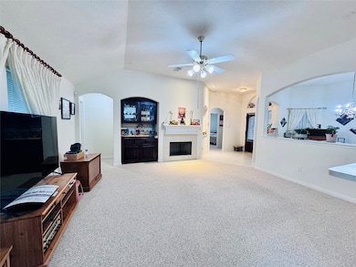 This spacious living room features a light carpet,