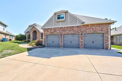 View of front of house with a garage, a front yard