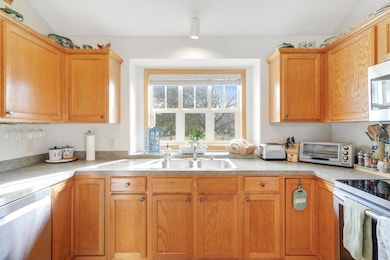 BRIGHT and Beautiful! This kitchen has tons of counter space, and ample storage. You'll love the 3 lazy susans in the cabinet corners.
