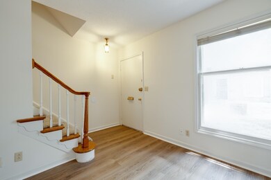 Foyer entrance featuring stairs and light wood finished floors