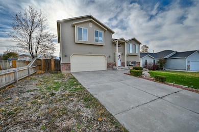 View of front of home with driveway, brick siding, and a garage