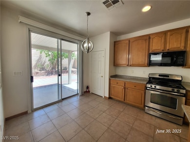 Kitchen featuring black microwave, stainless steel