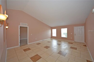 The living room has 2 large windows and cathedral 