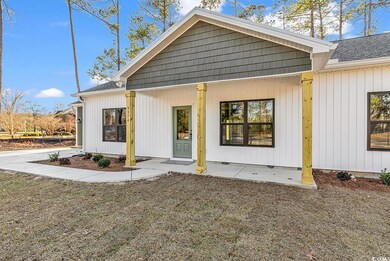 Rear view of property featuring a shingled roof