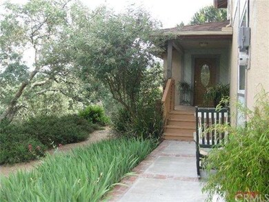 A view from the driveway at the home. Nestled agai