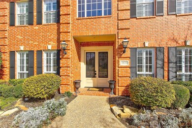 Welcoming entry has double doors with decorative i