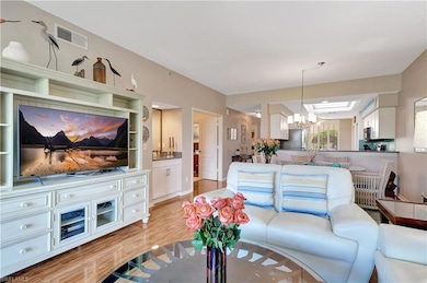 Living room with light wood-style floors, visible 
