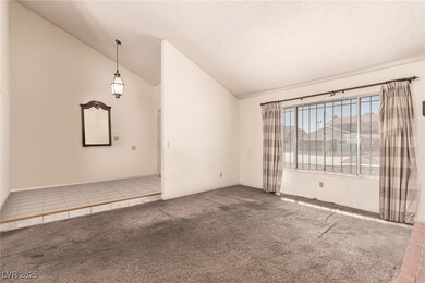 Spare room featuring tile patterned floors, lofted