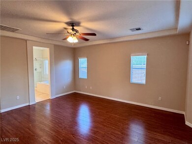 Spare room featuring a textured ceiling, wood fini