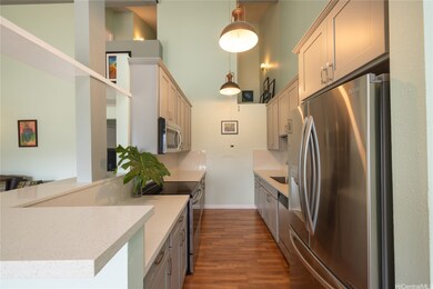 Modern galley kitchen with quartz countertops, sta
