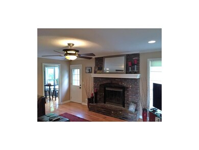 This cozy family room features a traditional brick