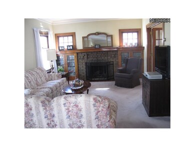 Cozy fireplace flanked by classic leaded glass bookcases.