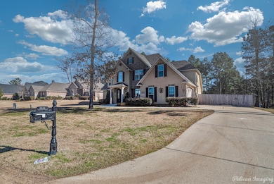 Traditional-style home with driveway and stucco siding