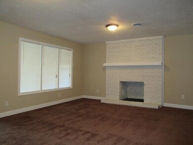 Unfurnished living room with baseboards, a firepla