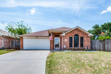 Ranch-style home with a garage and a front lawn