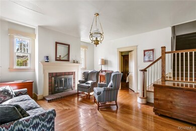 Hardwood floored living room featuring a fireplace