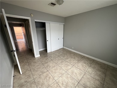 Unfurnished bedroom featuring baseboards, a closet
