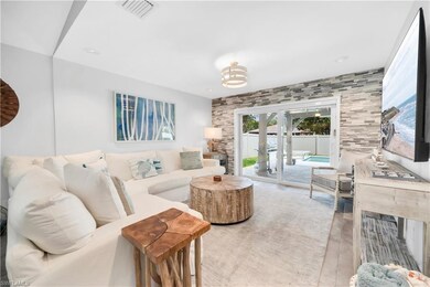 Living area with french doors and light wood-type flooring