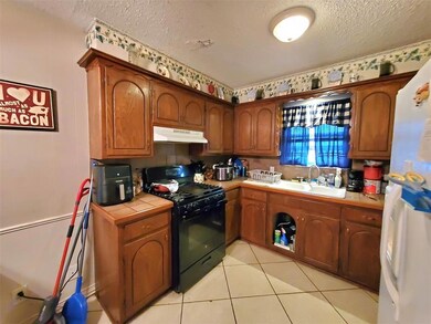 Kitchen featuring black range with gas stovetop, a
