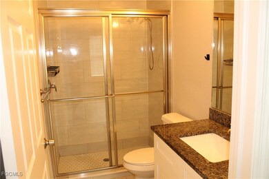 Bathroom with vanity and a shower stall