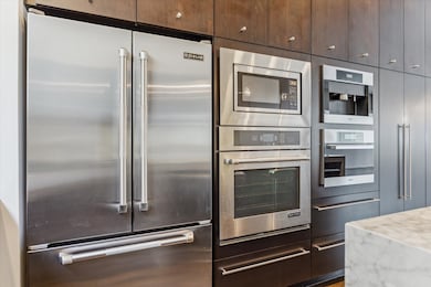 Stainless steel Jenn-Air refrigerator, oven and microwave.