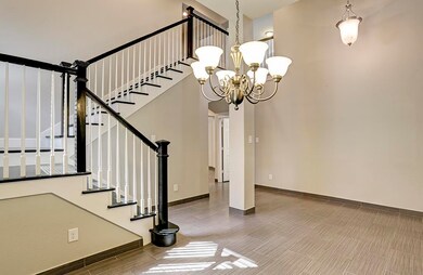 Aesthetically pleasing with its soft gray walls this hard wood staircase with white spindles adds so much charm to this great home.