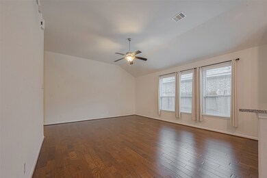 The distressed hardwood flooring flows throughout