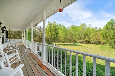 Deck featuring a yard and ceiling fan