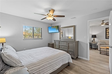 Bedroom with light wood-type flooring and ceiling