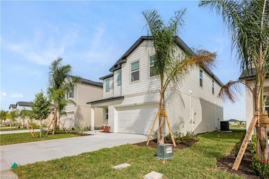 View of front of house with a front yard, stucco siding, concrete driveway, and an attached garage