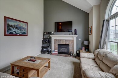 You'll love the cozy fireplace and vaulted ceiling