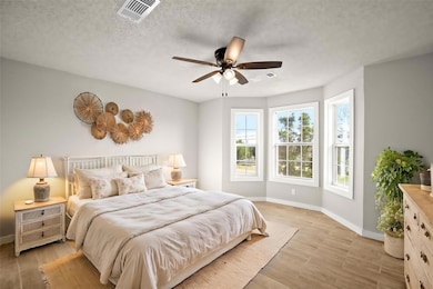 Bedroom with baseboards, light wood finished floo