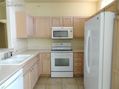 Kitchen with light tile patterned flooring, light 