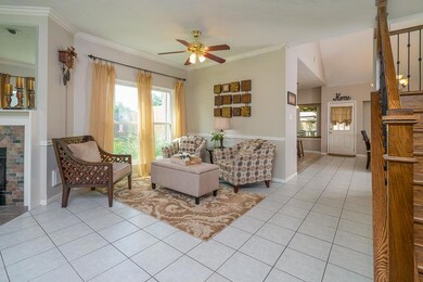 Continue through this open floor plan into the dining room, that is currently used as a sitting room.  Similar to the family room, this room offers a lighted ceiling fan, fresh paint, crown & chair molding, tile floors & easy access to the kitchen.