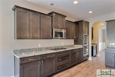 Kitchen is completed with stainless steel applianc