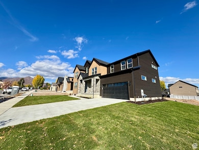 View of front of property featuring driveway, a front yard, a garage, and a residential view