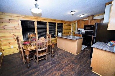 Kitchen featuring black appliances, a sink, brown 