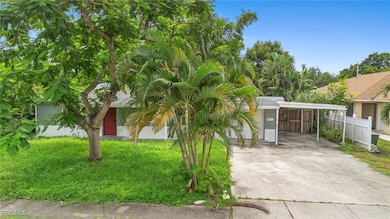View of front of house with a carport and concrete driveway