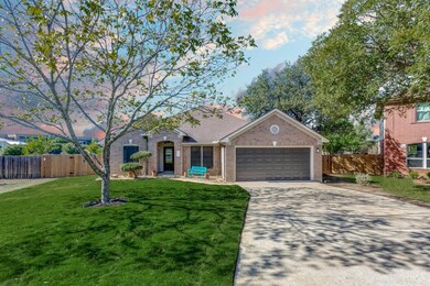 View of front of home featuring concrete driveway, brick siding, and an attached garage