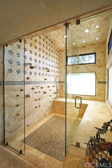 Spacious double shower/ steam room featuring 12 bo