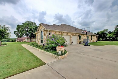 View of side of property featuring stone siding, 