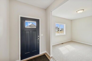 Entryway and bedroom/flex room -  photo is of a previous inventory home. Inquire for more details and options.